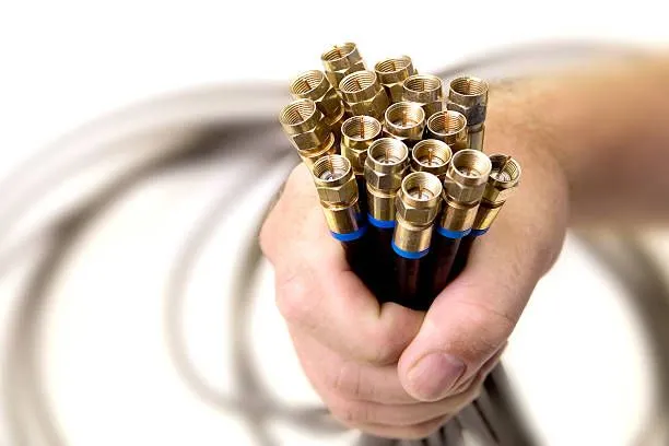 A person is holding a bunch of cables in their hand.