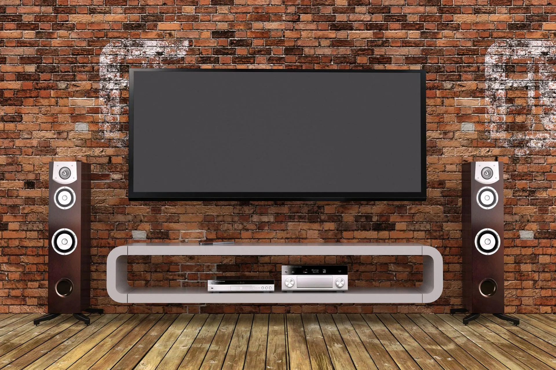 A flat screen tv is hanging on a brick wall next to two speakers.